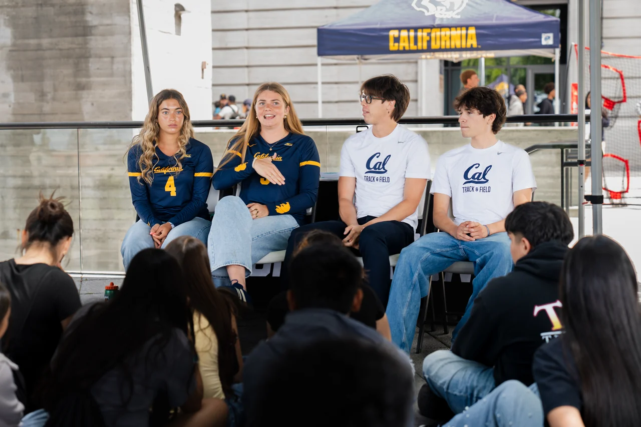 Four Cal athlete mentors talking with the seated student audience at Berkeley IGTC