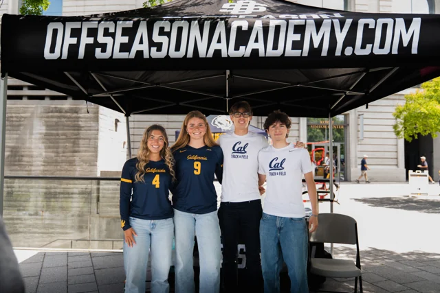 Four Cal athlete mentors together beneath the Offseason Academy canopy at Berkeley IGTC