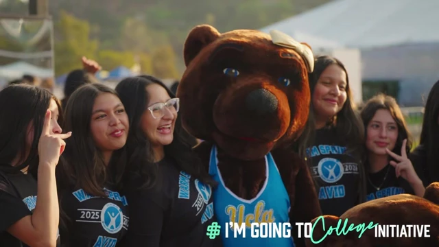 Students smiling with the UCLA mascot in blue and gold during IGTC