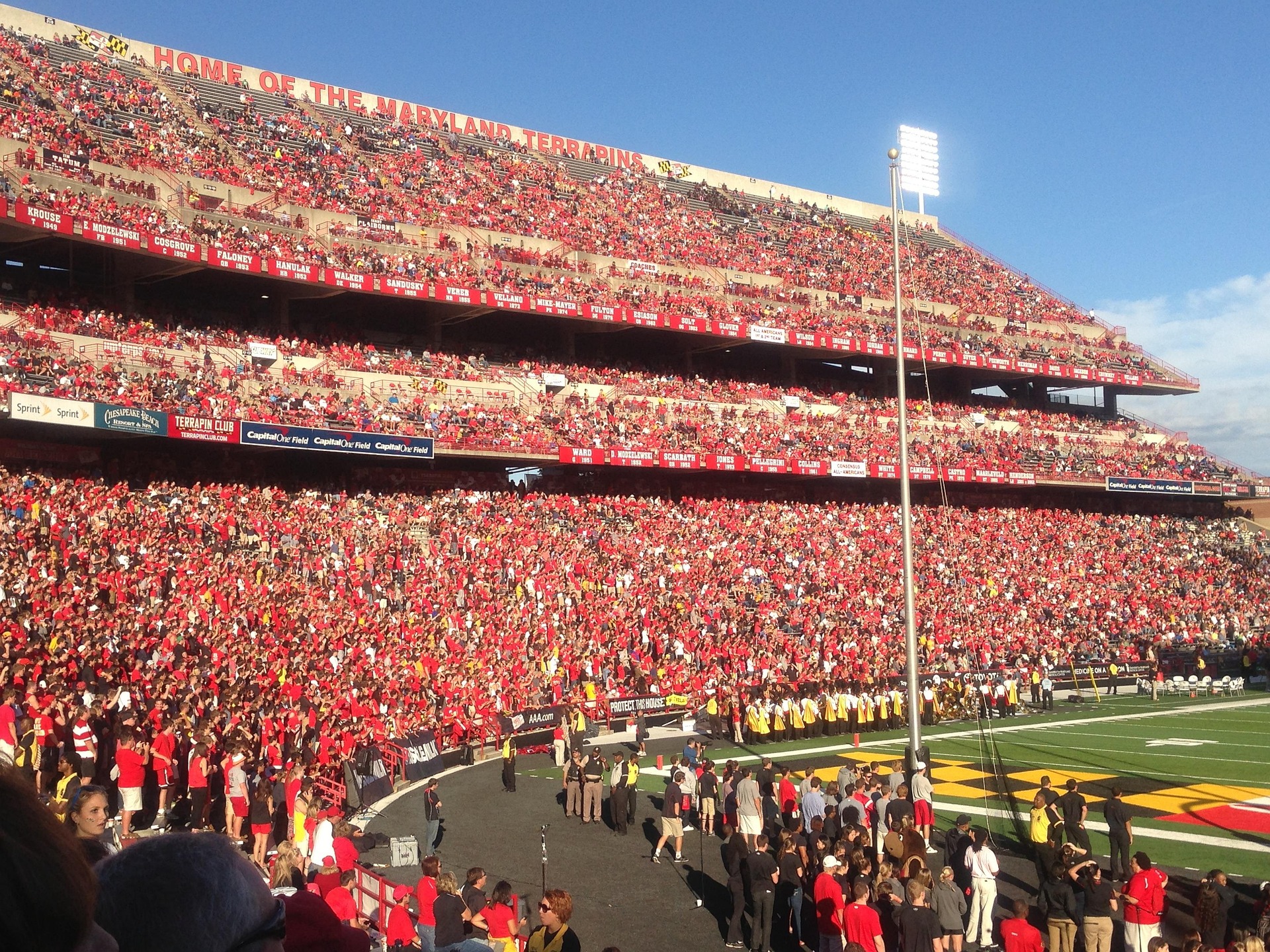 Packed college football stadium on game day with thousands of fans
